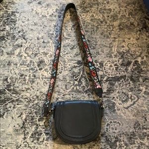 Black vegan leather crossbody bag with floral strap